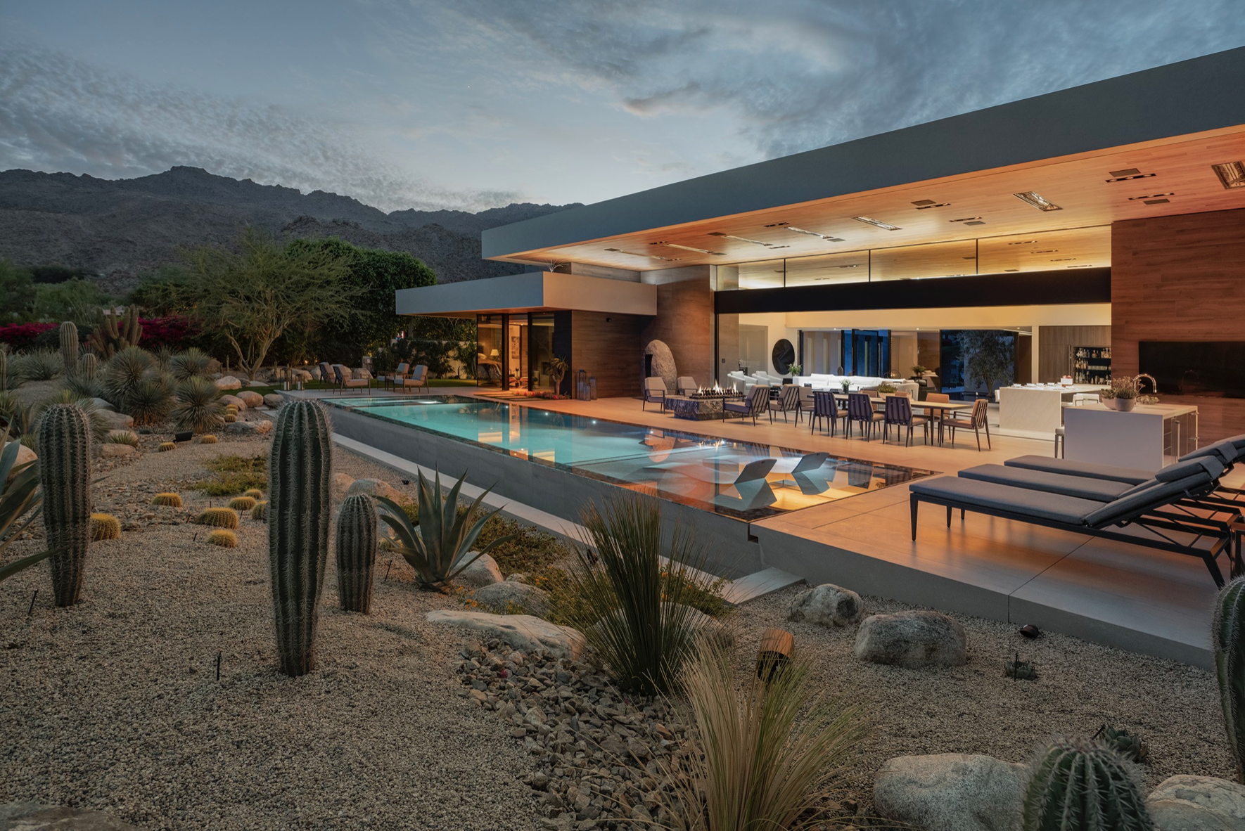 Modern desert home with pool at sunset