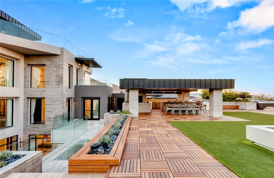 Outdoor lounge and pool beneath a covered patio